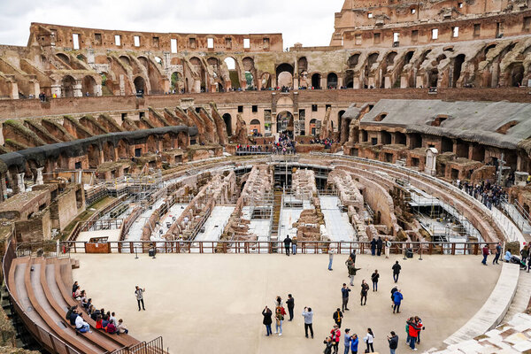 ROME, ITALY - APRIL 10, 2020: people walking in historical colosseum 