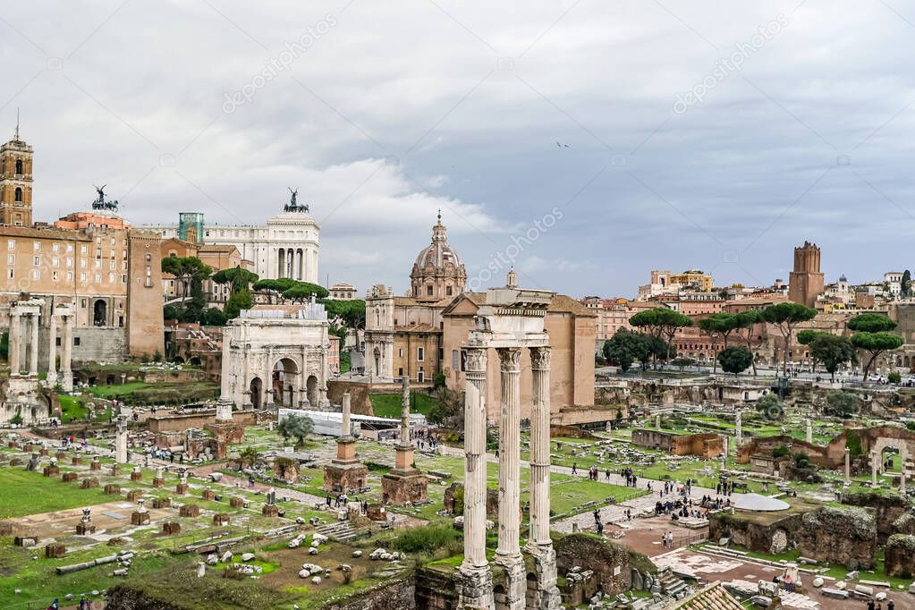 historical roman forum against sky with clouds in italy 