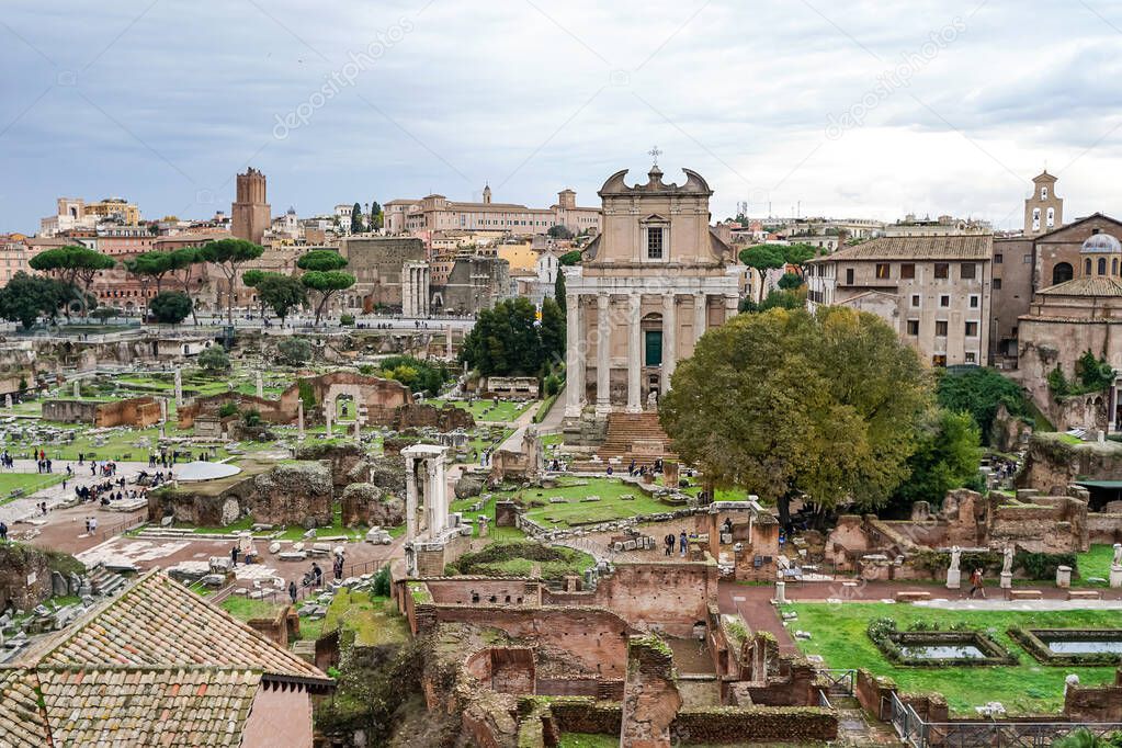 historical ruins of roman forum against blue sky with clouds in rome
