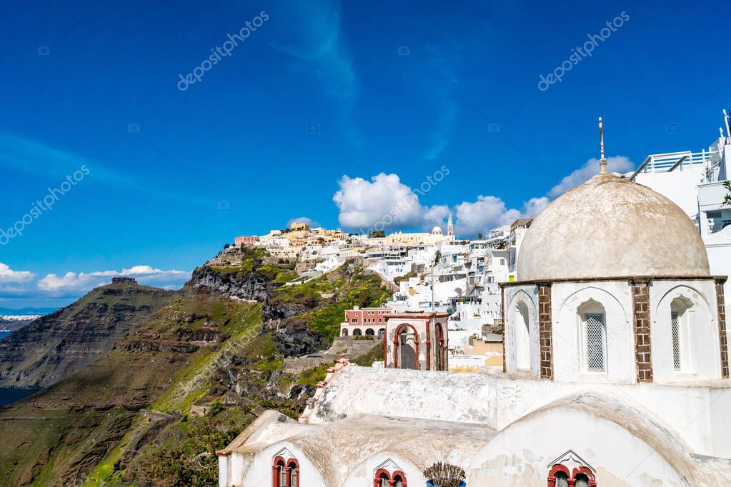 sunlight on church near white houses in greek island 