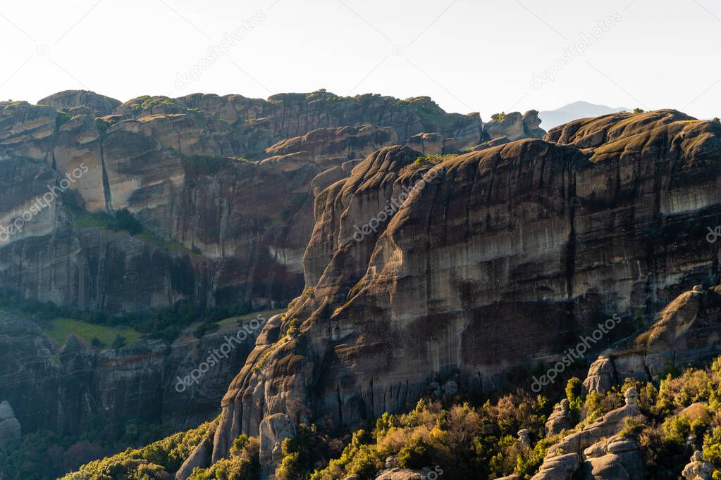 sunshine on rock formations in mountains against sky 