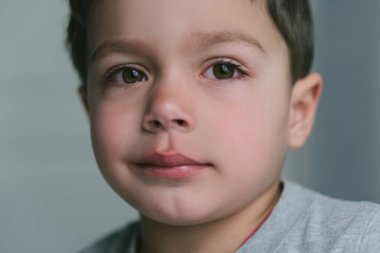 close up of upset toddler boy looking at camera  clipart