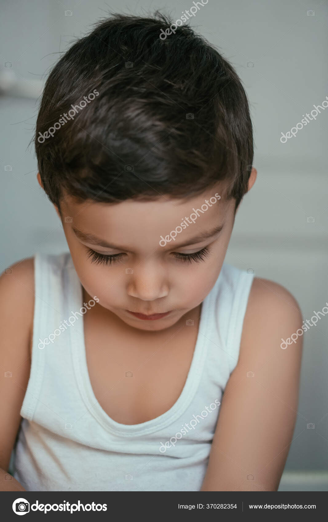 Thoughtful Boy Singlet Sitting Bowed Head Stock Photo by ©DimaKozitsyn 370282354
