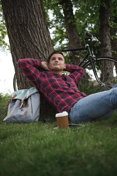 Homme relaxant avec tasse de café au parc — Photo de stock