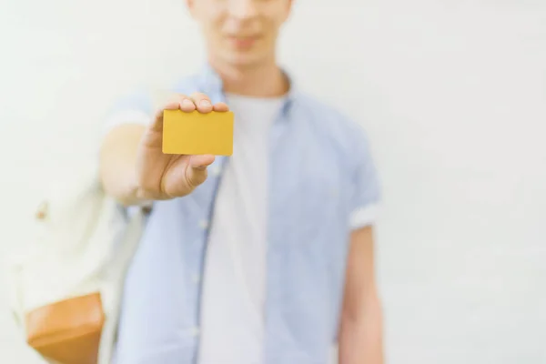 Cropped shot of young man holding golden card — Stock Photo