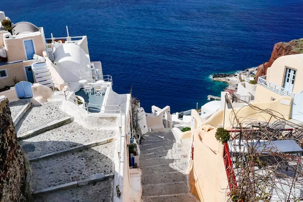 Sunshine on houses and stairs near blue sea in greece — Stock Photo