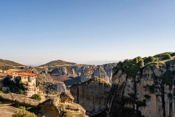 Orthodox monastery on rock formations against blue sky in meteora — Stock Photo