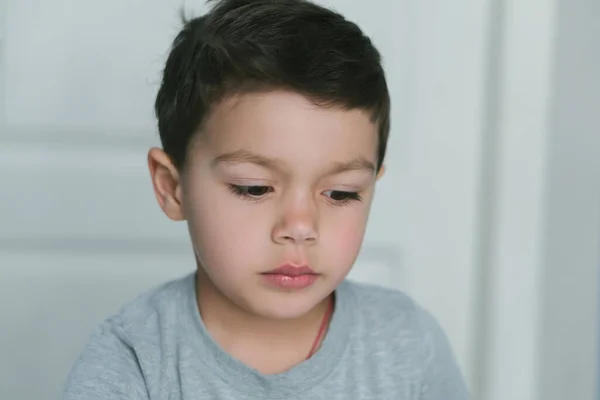 Thoughtful toddler boy looking down at home — Stock Photo