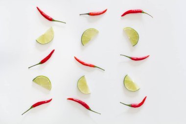 Desen kırmızı biber sıcak ve limes beyaz bir arka plan üzerine dilimlenmiş. Asya türler.