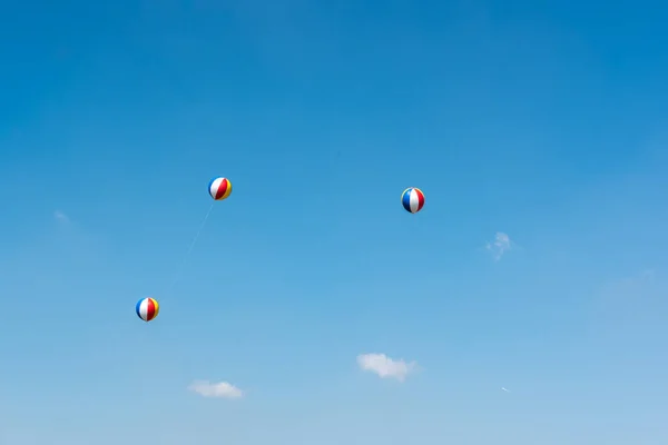 Kleurrijke ballen tegen blauwe hemel met kopie ruimte — Stockfoto