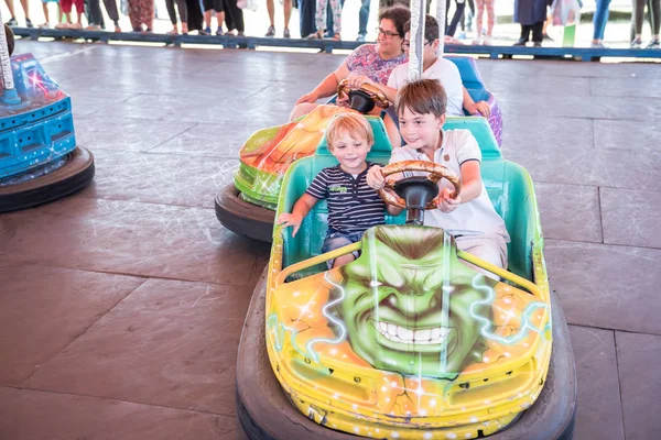 Crianças e crianças se divertindo no parque de diversões — Fotografia de Stock