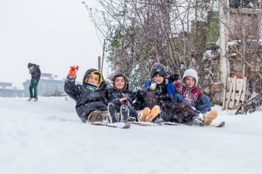 Çocuk Istanbul.Happiness ve sevinç kavram parke kızak ile eski okul tarzı karda kaydırın. Istanbul,Turkey.31 Aralık, 2015