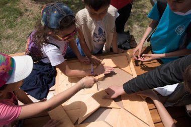 Kimliği belirsiz çocuk geleneksel Türk ahşap puzzle oyna. Etnospor Kültür Festivali bileziğinde bulunmakta. Istanbul, Türkiye, 13,2017 olabilir