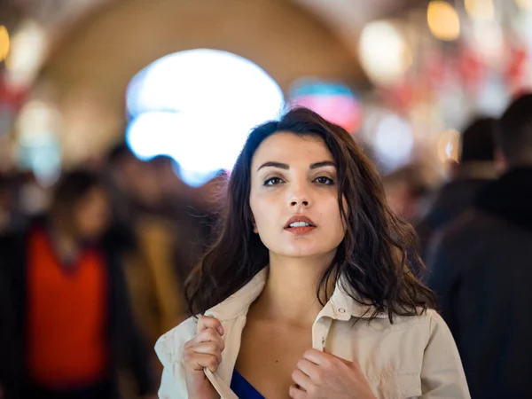 Portrait of beautiful woman in fashionable modern clothes stands among people in grand Bazaar,Istanbul,Turkey.Modern women lifestyle business or travel tourist concep