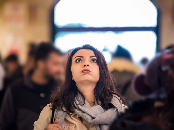 Beautiful woman in fashionable modern clothes suffers social anxiety attack problem while standing crowd of people at road