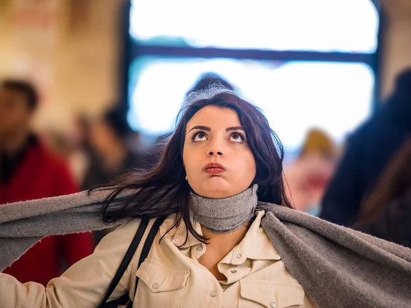 Beautiful woman in fashionable modern clothes suffers social anxiety attack problem while standing crowd of people at road