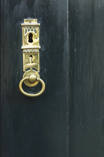 Porta verde escuro com buraco chave dourada — Fotografia de Stock