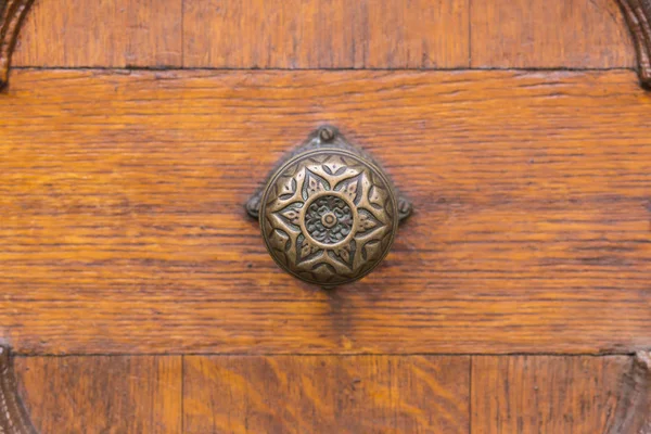 Round brass door knob with decor