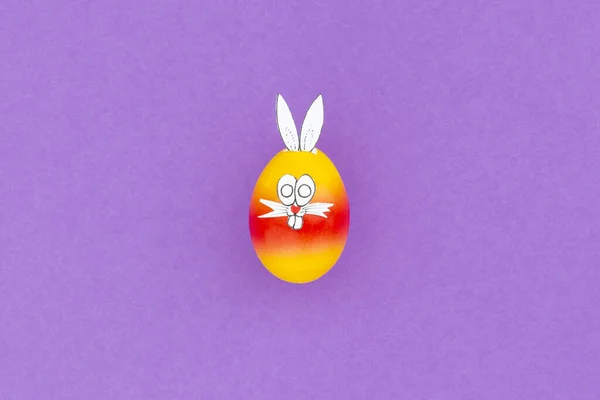 Красочные Окрашенные Пасхальные Яйца Смешными Кроличьими Ушами Мультяшным Лицом Фиолетовом — стоковое фото