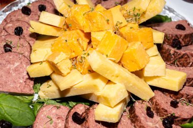 Brunch büfesi sırasında bir tabakta peynir dilimi karışımı. Lezzetli taze peynir çeşitleri, çeşitli süt ürünleri, brunch büfesi sırasında sunuluyor. Fransız veya İtalyan aperatif tabakları