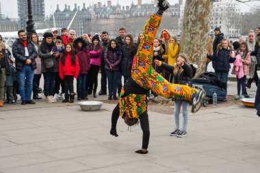Londra, Birleşik Krallık, 24 Ocak 2020: Brezilyalı akrobatik dansçılar Londra yakınlarındaki bir sokakta, nehir kenarında Thames nehrinde, kalabalıkla alkış tutuyorlar.