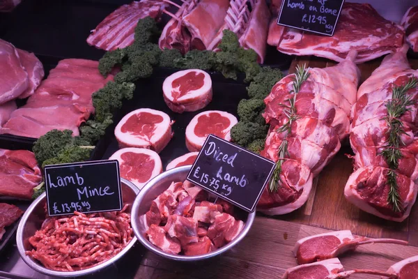 Various Meat cuts exposed in the butchery fridge counter. Raw meat in assortment in a butcher shop