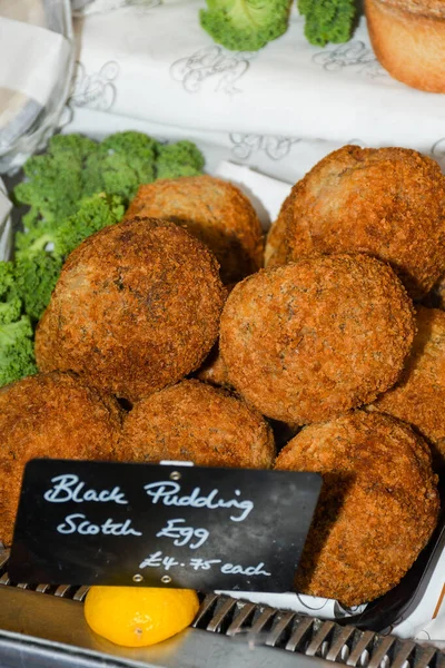 Black pudding Scotch egg. A Scotch egg consists of a whole soft or hard-boiled egg wrapped in sausage meat, coated in bread crumbs and baked or deep-fried.