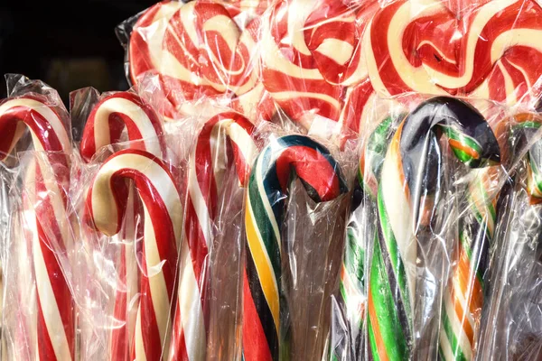 Candy canes displayed on a Christmas Market in Europe. Display on a Christmas candy market stall. Holidays street market, confectionery shop