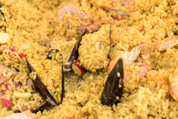 Seafood paella cooked in a large pan wok, street food festival. Mexican fiesta national day dish specialty. Live cooking station. Fresh Food Buffet Brunch Catering Dining Eating Party Sharing Concept