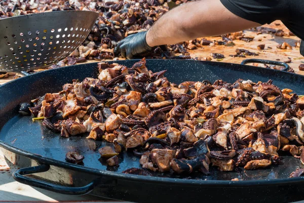 Octopus small chopped bites, street food festival. Seafood festival. Live cooking session contest. Fresh Food Buffet Brunch Catering Dining Eating Party Sharing Concept. Finely chopped octopus tentacl