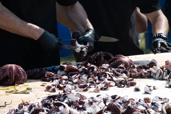 Octopus small chopped bites, street food festival. Seafood festival. Live cooking session contest. Fresh Food Buffet Brunch Catering Dining Eating Party Sharing Concept. Finely chopped octopus tentacl