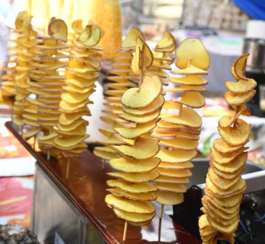 Sokak yemeği festivali sırasında patates sarmalı kızartılmış. Fast food. Bambu çubuğunda kasırga patatesleri