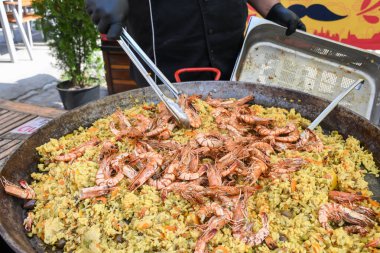 Deniz ürünleri paella 'sı büyük bir tavada pişmiş, sokak yemeği festivali. Meksika Fiesta Ulusal Yemek Günü spesiyali. Canlı yemek istasyonu. Taze Yemek Büfesi Yemek Yemeği Paylaşım Partisi Konsepti