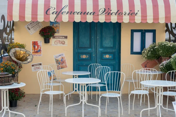 stock image Bucharest, Romania, 1st of September 2019: Retro vintage blue wooden door and white chairs, cafeteria cafe setting postcard