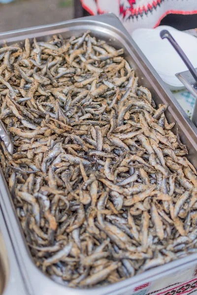 Fried little fish in market or food festival, food truck, asian market. Live cooking station. Mixed deep-fried crispy fish seafood, street food