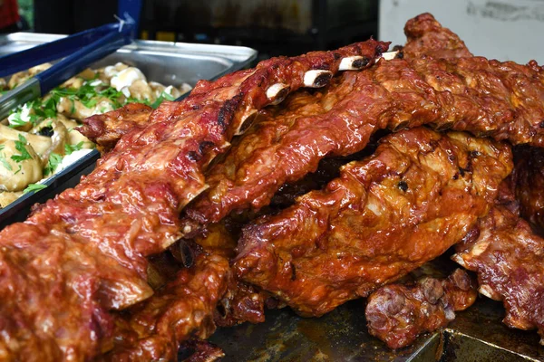 Grilled and barbecued ribs pork. Tasty traditional american meat. beef and pork ribs cooked in BBQ smoker.Tasty grilled spare ribs covered in barbecue sauce