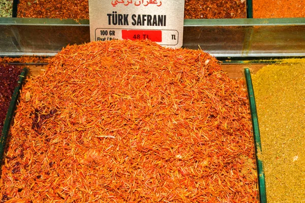 Raw Organic Red Saffron Spice in a Bowl.Luxurious flavour and expensive spices conceptual idea with close up on loose saffron spice in golden bowl in turkish Grand Bazaar