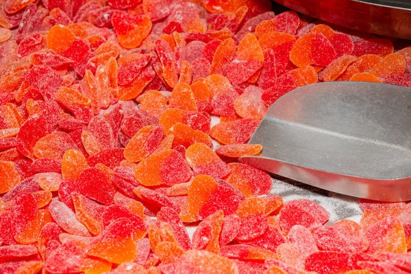 Many varied colorful candies for sale at the market. Kids and children sweet dessert mix treats. Jelly and gums, marmelade gummy bears
