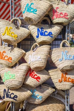 Straw bags gift souvenirs for the beach at the Nice market, Provence, street life. clipart