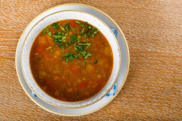 Fresh lentil soup in a white bowl, served in a restaurant setting, selective focus. Fresh Food Catering Dining Eating Party Sharing Concept, food delivery menu