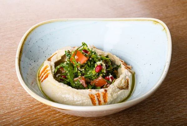 Hummus is a dip, spread, or savory dish made from cooked, mashed chickpeas blended with tahini, lemon juice, and garlic. It is popular in the Middle East and Mediterranean, as well as in Middle East