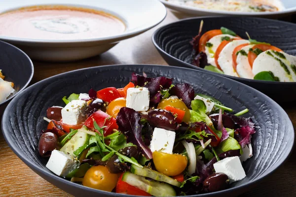 Greek salad or horiatiki salad is a salad in Greek cuisine. Greek salad is made with pieces of tomatoes, sliced cucumbers, onion, feta cheese, and olives, typically seasoned with salt and Greek mounta
