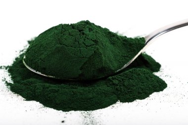 Beyaz ya da kırsal arkaplanda kurumuş organik spirulina alglerinden oluşan izole bir çorba kaşığı. Sağlıklı yaşam, detoks tarifleri, çiğ vejetaryen içeceği veya meyve suyu malzemeleri.