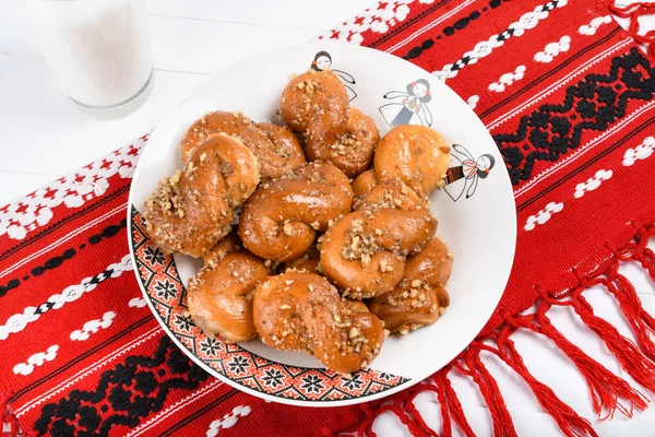 Stock image Concept of romanian cuisine. Homemade Mucenici, traditional desserts made in the figure 8 to look like garlands, smeared with honey and chopped nuts.