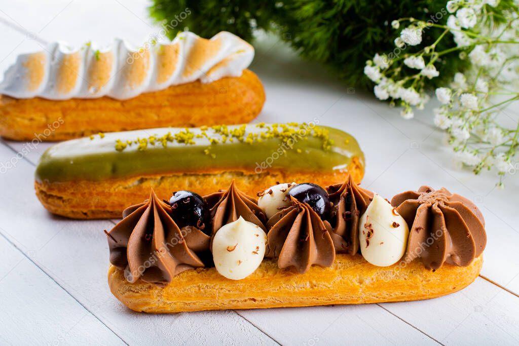 Eclairs pastry made with choux dough filled with cream and topping. Elegant, luxurious, expensive confectionery concept. Fresh Food Buffet Brunch Catering Dining Eating Party Sharing Concept