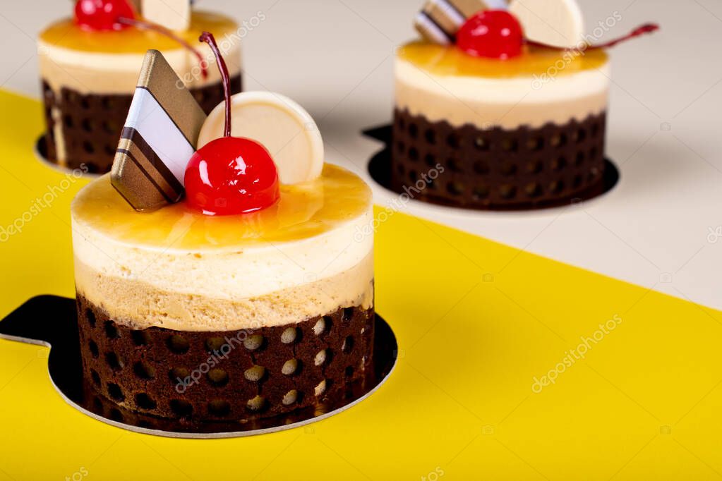 Mango & passion fruit cake dessert mousse. Minimalist conceptual design, flat lay with space for copy text, simple colorful paper background. Sweet confectionery ideal visual for advertising