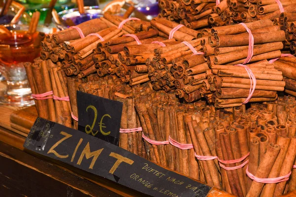 Bunch of cinnamon sticks for sale on counter top at the Christmas market. Healthy aromatic spice used in cooking and medicine, aromatherapy