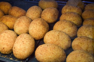 Arancini (bol etli kızarmış pirinç topları) İtalya 'daki markette tipik Sicilya sokak yemekleri. Sokak yemeklerinde satılacak bir sürü kızarmış pirinç topları.