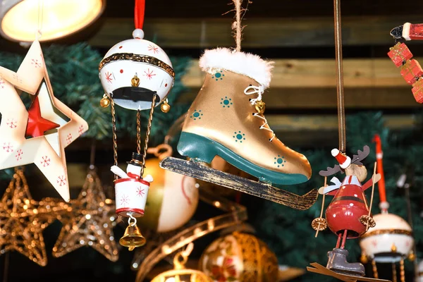 Christmas decorations on the market in Vienna. For sale on Christmas fair in Western Europe, Vienna, Austria. Golden boots, reindeer, ice skating, skates