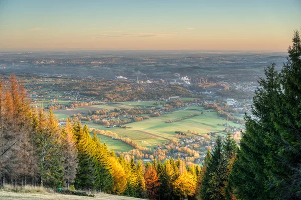 View of a valley full of industry that smokes and house from the mountain at sunrise in autumn , czech , trinec — Stock Photo, Image